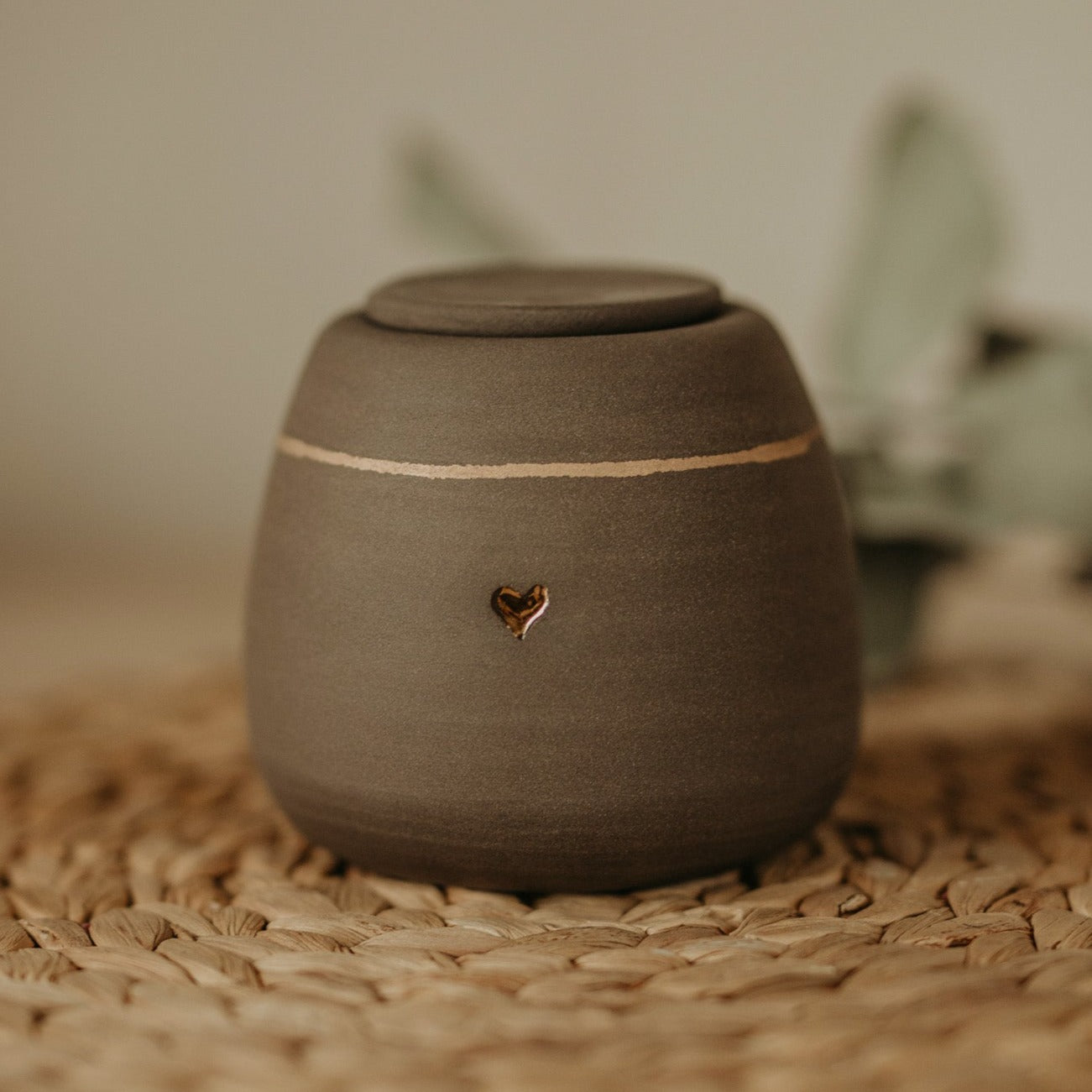 Customizable gray stoneware pet memorial urn - adorned with gold accent - cherished remembrance for your loyal companion.