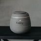 Handcrafted gray stoneware dog urn with gold heart stamp - personalized with dog's name.