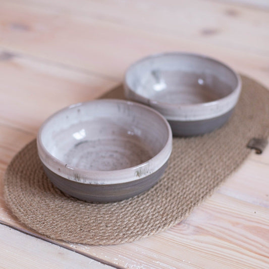 Gray speckled ceramic dog bowls with jute mat. Set includes 2 bowls for food and water.