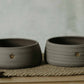 Medium-sized gray stoneware dog bowls - adorned with charming paw print - pet mealtime upgrade.