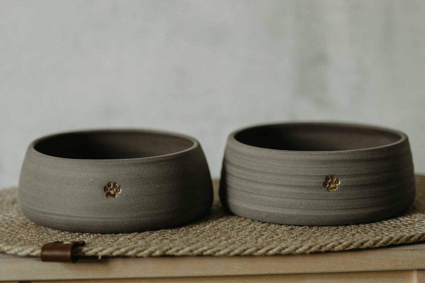 Medium-sized gray stoneware dog bowls - adorned with charming paw print - pet mealtime upgrade.